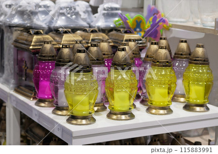 Memorial lamps of various colors are sold in store. Christian memorial lamps in shop. 115883991