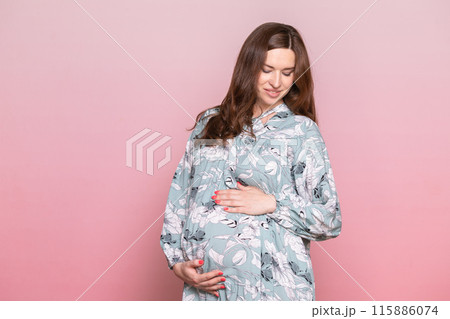 Pregnant Woman in Floral Dress Holding Belly Pregnant Woman in Floral Dress Holding Belly 115886074
