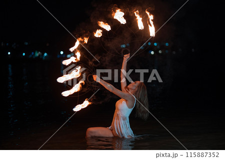 Caucasian woman dancing with fire in the water. Fire show at sea. Acrobatics on the beach. Yoga and relaxation at sunset. Spectacular circus performance. model body. High quality FullHD footage. Caucasian woman dancing with fire in the water. Fire show at sea. Acrobatics on the beach. Yoga and relaxation at sunset. Spectacular circus performance. model body. High quality FullHD footage. 115887352
