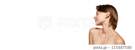 Banner. Woman with short brown hair tilts her head back against white studio background with negative space to insert your text. 115887580