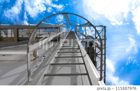 Industrial ladder to the roof of the building. Concept of aspiration and career Industrial ladder to the roof of the building. Concept of aspiration and career 115887976