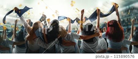 Banner. Fans, dressed in blue, passionately cheer and gesture towards field, creating electrifying atmosphere inside stadium. Banner. Fans, dressed in blue, passionately cheer and gesture towards field, creating electrifying atmosphere inside stadium. 115890576