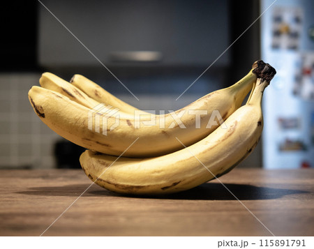 bunch of bananas on a wooden table. High quality photo bunch of bananas on a wooden table. High quality photo 115891791