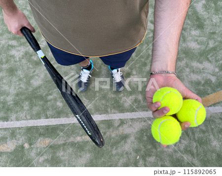 High Angle Of A Tennis Player With Balls And Racket High Angle Of A Tennis Player With Balls And Racket 115892065