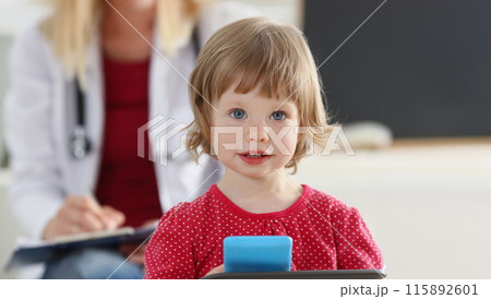 Portrait of little girl on background of doctor in white coat. 115892601