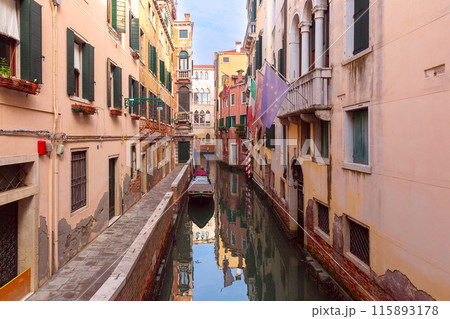 Traditional brick Venetian houses over a canal on a sunny day. 115893178