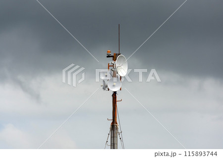 Wireless data station aerial view Against a cloudy sky. Cell tower Wireless data station aerial view Against a cloudy sky. Cell tower 115893744