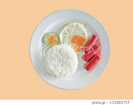 Breakfast on a white plate including sausages, rice, fried egg, fresh vegetables isolated on peach background Breakfast on a white plate including sausages, rice, fried egg, fresh vegetables isolated on peach background 115893757