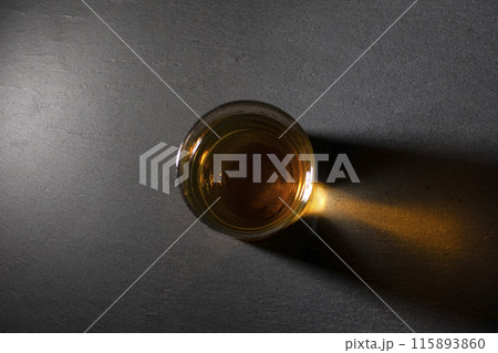 glass with whiskey on a dark background top view glass with whiskey on a dark background top view 115893860
