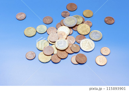 a handful of euro cent coins on a blue background a handful of euro cent coins on a blue background 115893901