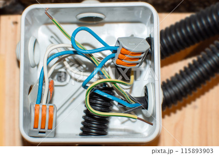 open electrical distribution box with connected wires 115893903