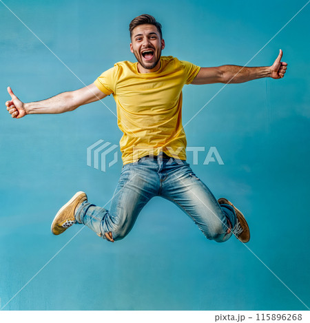 Man in yellow shirt jumping in the air with his hands in the air. Man in yellow shirt jumping in the air with his hands in the air. 115896268