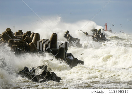 Storm season, big waves breaking on concrete tetrapods breakwater on Baltic sea Liepaja harbour Storm season, big waves breaking on concrete tetrapods breakwater on Baltic sea Liepaja harbour 115896515