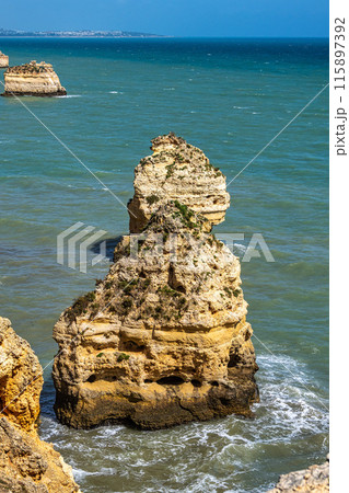 Praia da Marinha Beach among rock islets and cliffs seen from Seven Hanging Valleys Trail, Algarve, Portugal Praia da Marinha Beach among rock islets and cliffs seen from Seven Hanging Valleys Trail, Algarve, Portugal 115897392