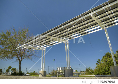 Wind damage to solar panels installed over parking lot canopy shade for parked cars for effective generation of clean energy Wind damage to solar panels installed over parking lot canopy shade for parked cars for effective generation of clean energy 115897698