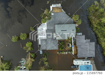 Surrounded by hurricane Ian rainfall flood waters homes in Florida residential area. Aftermath of natural disaster Surrounded by hurricane Ian rainfall flood waters homes in Florida residential area. Aftermath of natural disaster 115897760