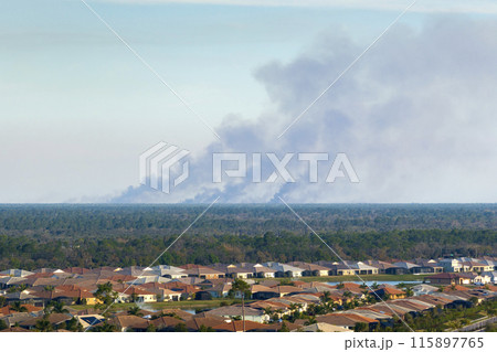 Air contamination with burning smoke from prescribed fire close to suburban area in Florida, USA 115897765