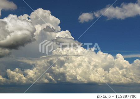 Blue sky with white summer rain clouds. Colorful summer landscape 115897780