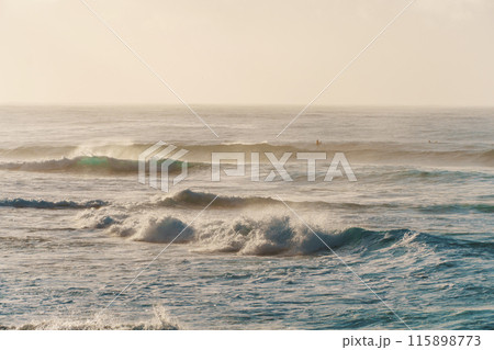 A slightly outoffocus image of waves breaking on a sandy shore 115898773