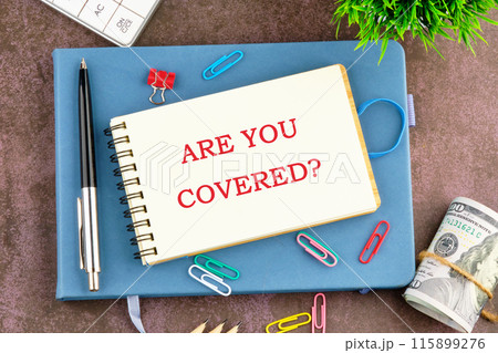 Business and Are you covered concept. Copy space. Concept word Are you covered symbol in the businessman's notebook Business and Are you covered concept. Copy space. Concept word Are you covered symbol in the businessman's notebook 115899276