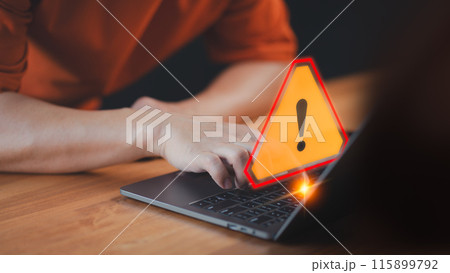 A caution warning sign alerts the user while using a computer laptop, emphasizing the importance of cyber security in detecting viruses, protecting personal data, and maintaining network security. 115899792