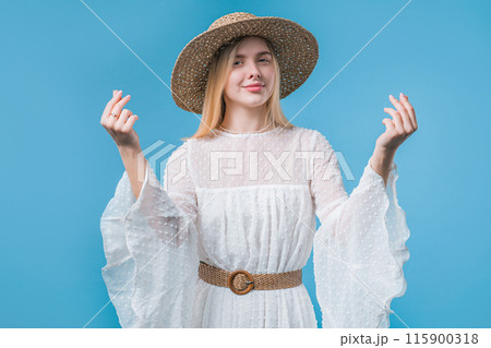 Young teenager girl with money gesture on blue studio. Rich smart lady smiling 115900318