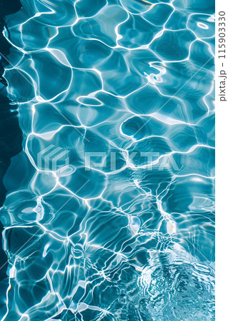 A closeup of the azure water surface in a swimming pool during daytime, showcasing the fluid nature of this body of water A closeup of the azure water surface in a swimming pool during daytime, showcasing the fluid nature of this body of water 115903330