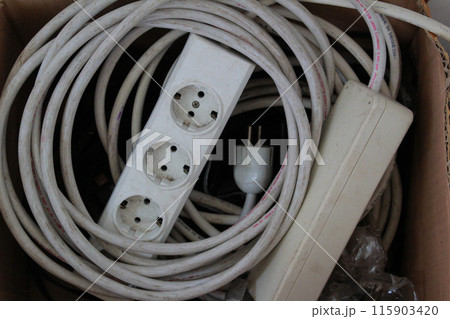 white electrical socket with cable coiled in a cardboard box white electrical socket with cable coiled in a cardboard box 115903420