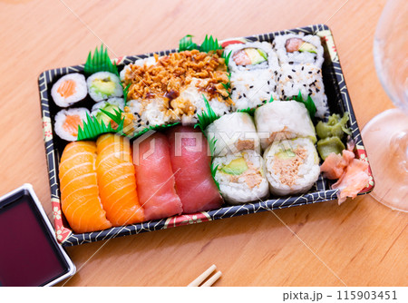Set of nigiri and sushi rolls with salmon, tuna, avocado, fried onions Set of nigiri and sushi rolls with salmon, tuna, avocado, fried onions 115903451