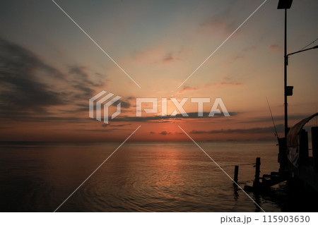 sunrise on the beach pier bridge with a clear sky 115903630