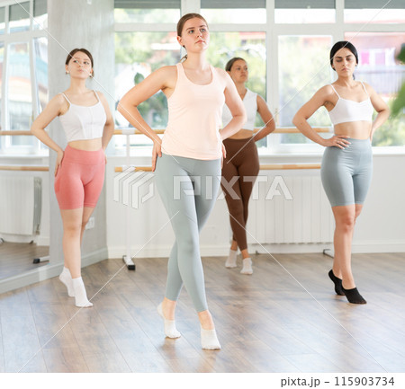 Group of oung ballerinas rehearsing ballet movements in the choreography studio 115903734