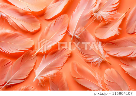 A vibrant display of pink feathers against an orange background, resembling a beautiful pattern on a flowering plant. The closeup shot captures the petallike shapes in a peachy hue 115904107