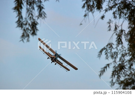 Old propeller plane in the sky 115904108