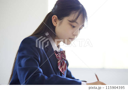 学校の教室で授業を受ける女子高生 115904395