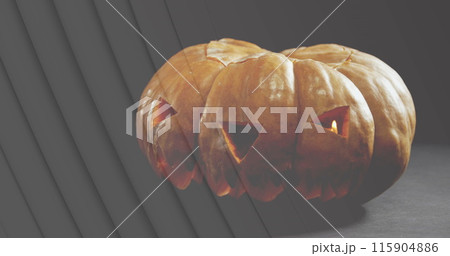 Image of lines over jack o lantern halloween pumpkin on grey background 115904886