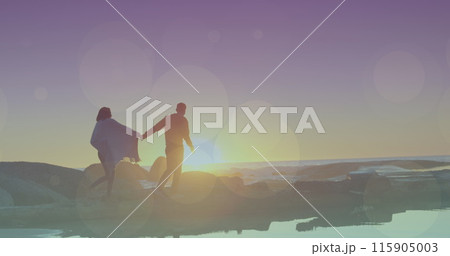 Flares over biracial couple walking on a beach 115905003