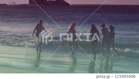 Image of glowing lights over group of female friends by the sea 115905006