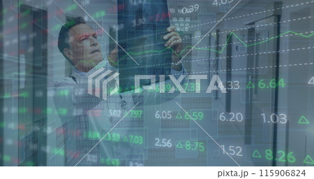 Image of financial data over caucasian male doctor with x ray photo Image of financial data over caucasian male doctor with x ray photo 115906824