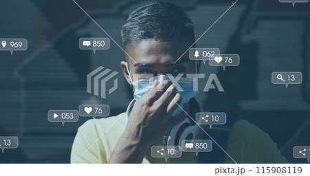 Image of social media icons over biracial man putting face mask on 115908119