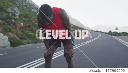Image of the words level up in white over man exercising on mountain road taking a rest Image of the words level up in white over man exercising on mountain road taking a rest 115909990