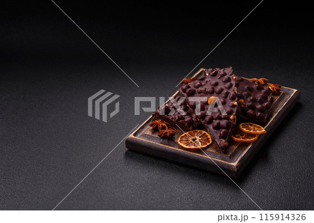 Black bitter chocolate with whole hazelnuts, candied fruits and mint 115914326