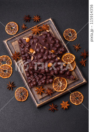 Black bitter chocolate with whole hazelnuts, candied fruits and mint 115914356