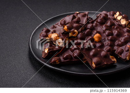 Black bitter chocolate with whole hazelnuts, candied fruits and mint 115914369