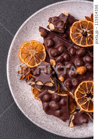 Black bitter chocolate with whole hazelnuts, candied fruits and mint Black bitter chocolate with whole hazelnuts, candied fruits and mint 115914398
