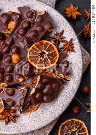 Black bitter chocolate with whole hazelnuts, candied fruits and mint Black bitter chocolate with whole hazelnuts, candied fruits and mint 115914404