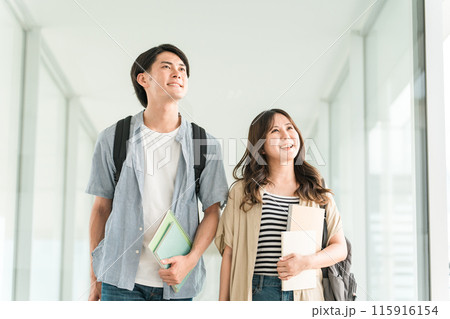 教科書・ノートを持つ学生・大学生の男女（キャンパスライフ・恋人・カップル） 115916154
