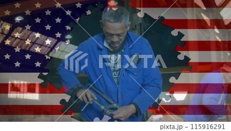 Image of American flag formed with puzzle pieces over senior biracial man working in factory in the 115916291