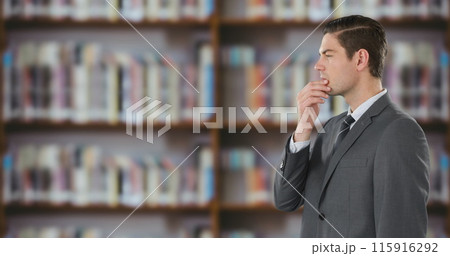 Side view of a businessman using a digital screen in a library 4k Side view of a businessman using a digital screen in a library 4k 115916292