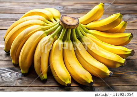 Bananas on a table, showcasing natural produce from the banana family 115923054