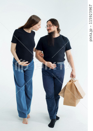 pregnancy, shopping, parenthood and happiness concept - happy young family with shopping bags  115923967